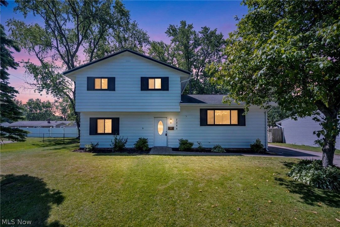 Welcome to this charming split-level home nestled in the heart of Mentor-on-the-Lake! Ideally situated just minutes from parks, shopping, walking trails, restaurants, and everyday conveniences, this home offers both comfort and convenience in a desirable location. As you step inside, you're welcomed by a cozy foyer featuring a convenient laundry room and an accessible half bath just off to the left. Continue into the spacious living room, the perfect place to unwind with a good book or gather for a relaxing movie night. Sliding glass doors open to a fully fenced backyard with a 6-foot chain-link fence, creating a safe and inviting space for children and pets alike to run, play, and enjoy the outdoors. A short flight of stairs leads to the bright and functional main living area, where the kitchen, dining room, and family room blend seamlessly together. This open, connected layout is ideal for entertaining guests, preparing meals, and staying connected with family and friends. Upstairs, you'll find three comfortable bedrooms and a full bathroom featuring slip-resistant flooring in the tub for added peace of mind and safety. Outside, a detached two-car garage provides ample space for vehicles, storage, hobbies, or a workshop. With its thoughtful layout, welcoming atmosphere, and convenient location, this wonderful home offers everything you need to create lasting memories. Schedule your showing today and discover whether this could be the perfect place to call home.