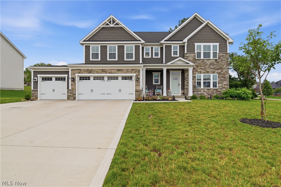 Skip the build and move right into this beautifully upgraded 5-bedroom, 3-bath home in the Fountains of Edgewood! Offering 2,782 square feet of thoughtfully designed living space, this popular Roanoke floor plan combines modern style with exceptional functionality. The open-concept main level features a spacious family room with a floor-to-ceiling stone gas fireplace, complete with smart activation, and a stunning kitchen showcasing an oversized quartz island, mosaic glass tile backsplash, walk-in pantry, stainless steel appliances, reverse osmosis drinking water system, and abundant cabinet space. A main-level bedroom and full bath provide the perfect setup for guests, multi-generational living, or a private home office. Upstairs, you'll find four additional bedrooms, a convenient second-floor laundry room, and a spacious primary suite with a tray ceiling, dual walk-in closets, and an ensuite bath. Ceiling fans have been added throughout all five bedrooms and the living room, while custom wood blinds are installed throughout the home. Step outside to enjoy the expansive 16' x 20' Trex composite deck featuring bar rail seating and LED lighting—perfect for entertaining or relaxing evenings at home. The full basement is already plumbed for a future bathroom and has an egress window, offering endless possibilities to finish the space to suit your needs. Additional highlights include a 3-car attached garage with Rubbermaid FastTrack storage system, dual water softener system, gas range, gas dryer hookup, RING doorbell and floodlight cameras, and dusk-to-dawn exterior lighting. Residents of Fountains of Edgewood also enjoy access to the community pool. This better-than-new home is truly move-in ready and loaded with upgrades throughout!