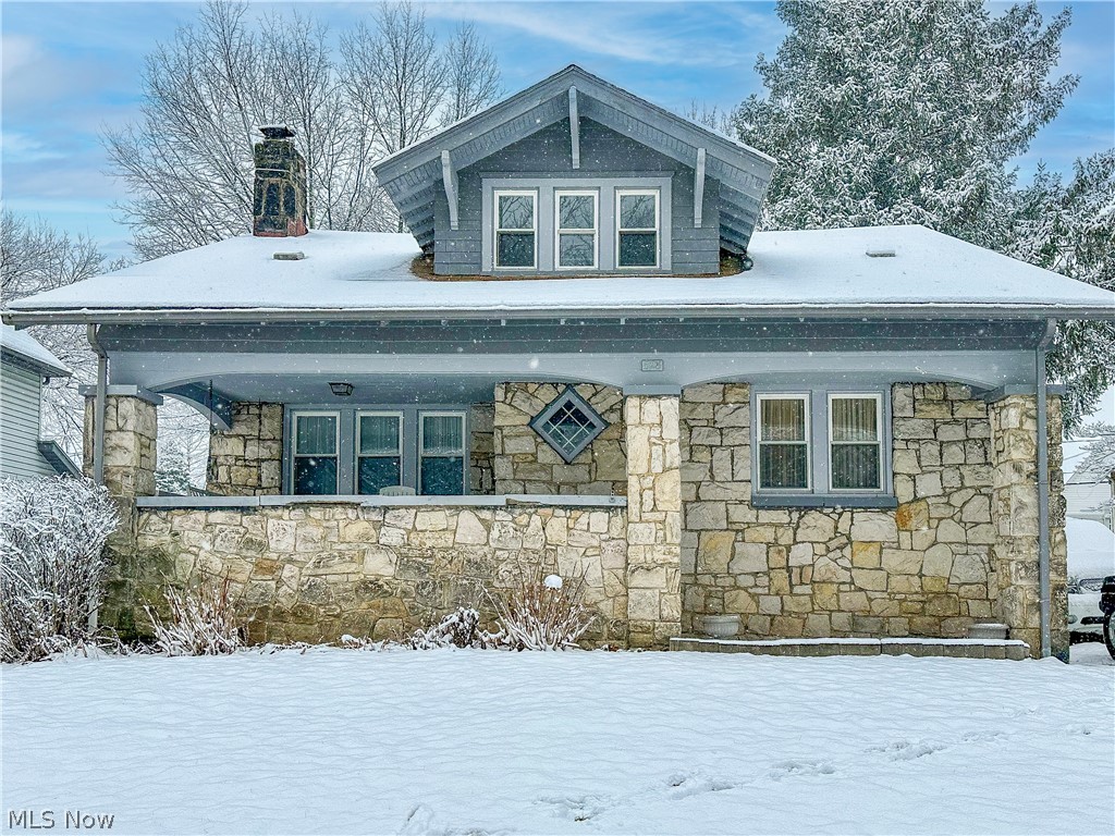 Welcome home to 528 Sunset View Drive! Don't miss this cozy stone-faced century home minutes from Highland square! Enter into a spacious living room boasting a wood burning fireplace and continue into a formal dining room with a window seat and built in cabinets. Your main level also offers a fully applianced kitchen and a half bath. Hardwood floors under all main level carpet! Three bedrooms and full bath are located on the upper level with plenty of closet space.
The walkout basement offers loads of shelves and storage space. Enjoy your summer evenings swinging on your front porch or entertaining guests in your private backyard. Don't miss your opportunity to own this home. Schedule your private viewing today!