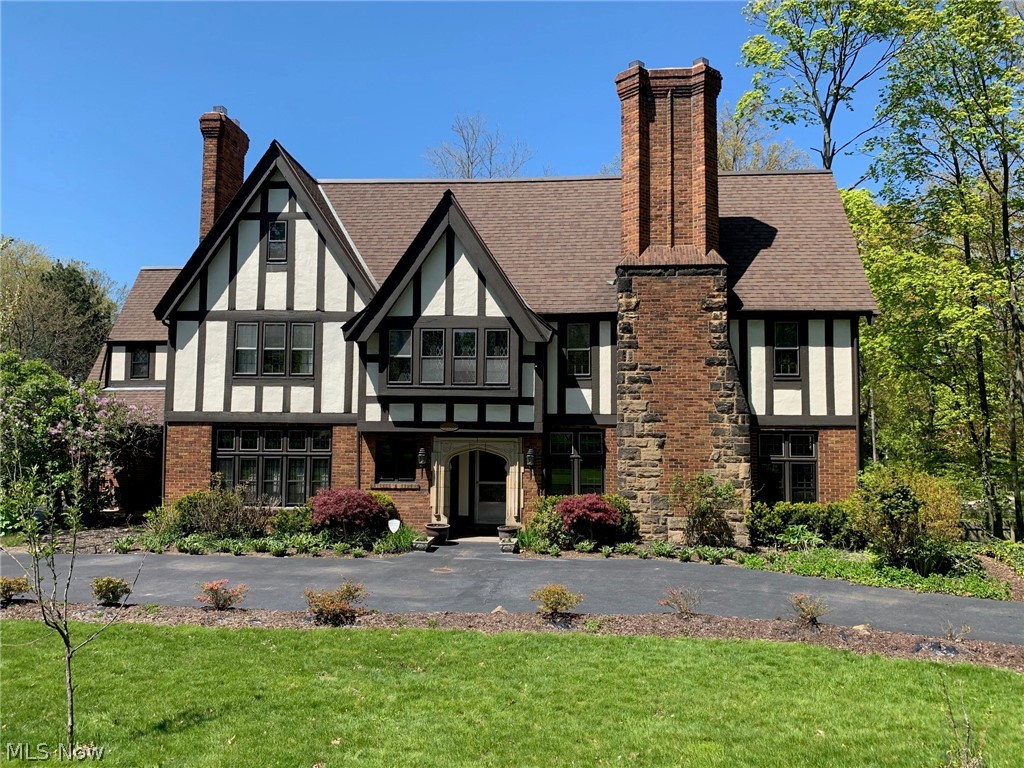 *** A MUST SEE ~ MOVE IN CONDITION ***  Absolutely STUNNING Tudor on a beautiful private, landscaped lot.  This exceptionally maintained and beautifully decorated 5/7 bedroom; 3 story;  4.5 bath home has had many major improvements and upgrades in the last 6 years.  Get the best of both worlds -  exquisite character and detailing coupled with today's amenities.  Incredible Chef’s kitchen (Major 2014 Renovation).  Custom cabinets with granite countertops and recessed refrigerator.  Deluxe Center  Island.   Appliances stay. French doors lead to the formal dining room.  Spacious living room with wood/gas burning fire place and mounted flat screen TV.  Exquisite crown molding in many rooms, original lead windows, chestnut hardwood flooring and fresh neutral paint color throughout the interior.  Paneled Conservatory/Den with wood/gas burning fireplace and built in book shelves.  Fabulous master suite with walk in closet and cozy gas fire place and recessed TV.   Second floor laundry room wi