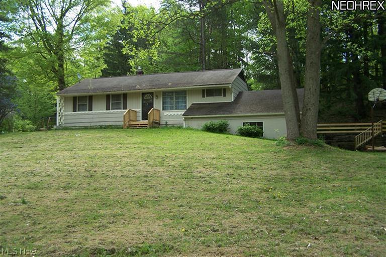 Newbury Schools!  Occupancy will be April 1st or later, are you a bit flexible? Raised ranch home.  Enter into the kitchen from the back by coming up the exterior landscaped hill and deck or enter the lower level through the large 2-car garage.  This lower level family room with some built-ins leads upstairs into the whole main floor or if you stay on the walk-in level, you have a bedroom, full bath with shower, storage/workshop room and the laundry/utility room.  This floor plan almost gives you a separate suite set up.  Nice newer kitchen with a stove and fridge.  The kitchen and dining area are right off the rear deck.  L/R & dining are spacious w/ hard wood floors.  Patio and woods galore for back yard, or play football or sports in open front yard; plenty of space to  sprawl in this wonderful ranch.  Over sized 2-car garage w/ pull down stair walk up