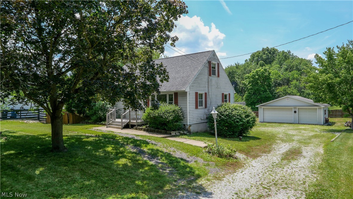 Welcome to this charming Cape Cod home in the highly sought-after Hudson School District, offering the perfect opportunity to add your personal style while building instant equity. Full of timeless character, this spacious home features hardwood floors throughout the main level. Enjoy a bright and inviting eat-in kitchen, two bedrooms on the first floor, and two additional bedrooms upstairs, providing flexibility for families, guests, or a home office. The walkout lower level offers additional potential for living space, an extra bathroom, and direct access to a concrete patio, creating endless possibilities for a recreation room, home gym, or entertaining area. Step outside to a large rear deck overlooking the expansive, partially fenced backyard—ideal for relaxing, gardening, or hosting family and friends. Car enthusiasts, hobbyists, or business owners will appreciate the heated three-car detached garage with electric, in addition to the attached one-car garage located in the basement. Major updates including a new roof and new septic system provide added peace of mind. This home is in the ideal location being conveniently located near Streetsboro and Hudson for shopping, dining, parks, and major commuter routes. This home combines classic Cape Cod charm, exceptional garage space, a large yard, and unlimited potential in one of Northeast Ohio's most desirable school districts.
