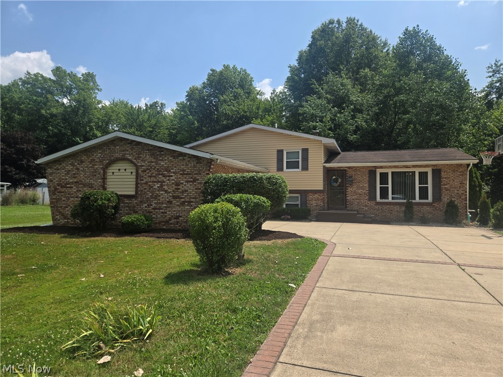 Welcome home to this beautifully maintained, spacious multi-level residence offering comfort, style, and plenty of room for family living and entertaining. This exceptional home features 4 spacious bedrooms and 2 full bathrooms. A beautiful, updated kitchen with all appliances included.  Cozy fireplace perfect for relaxing evenings.  A finished basement providing additional living space. Large, enclosed back patio ideal for year-round enjoyment.  A huge backyard with plenty of room for outdoor activities. An attached 2 car garage for convenience and storage. Whether you're hosting gatherings or enjoying quiet family time, this home has everything you need. Don't miss the opportunity to make this move-in ready gem your own!