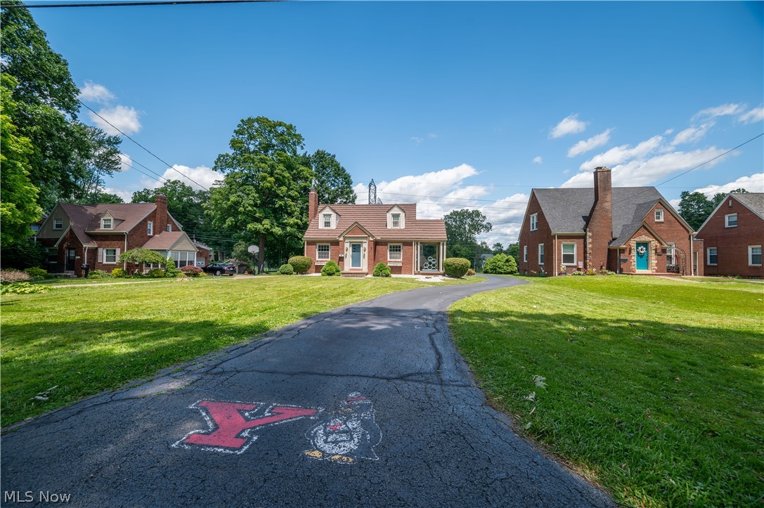 Wow, this is a great chance at a unique brick cape in the heart of Boardman! Charming characteristics at every turn. If you are looking for a unique and custom finished basement with amazing potential to make your own wait until you see this unbelievable remodel that was done in this cape cod home! Driving by, your eye might catch the charming exterior. Pull on into the drive, Enter into the foyer and thru to a huge freshly painted living room dining room combo with hardwood floors and a great gas fireplace. Tucked off the formal dining is a great covered side porch. Quaint breakfast nook leading to the kitchen. The kitchen has a lot of great cabinet space and a built in spice rack and pantry cupboard. All appliances stay for you. First floor master even has its own door to the first floor half bath, given a fresh face lift with an addition of new flooring installed June 2026. Upstairs is a nice sized full bath with built in linen closet and a laundry chute. Two large bedrooms with nice closet space and built in dressers and pretty hardwood flooring! You will be so excited to see this basement, there is a great wet bar area and a family room area for enjoyment! The awesome custom hand painted brink wall gives you an added charm and the retro style was revamped to match! Unfinished area for utility items and laundry. Washer and dryer to stay. Additional stand up shower as well. Small workshop and a fruit cellar as well. 200 Amp Electrical panel. Newer hot water tank. Blown in insulation for heat bill savings. This is one you will want to see in person because the character and charm will really make you fall in love! Call for your showing so that you can make this find your own!