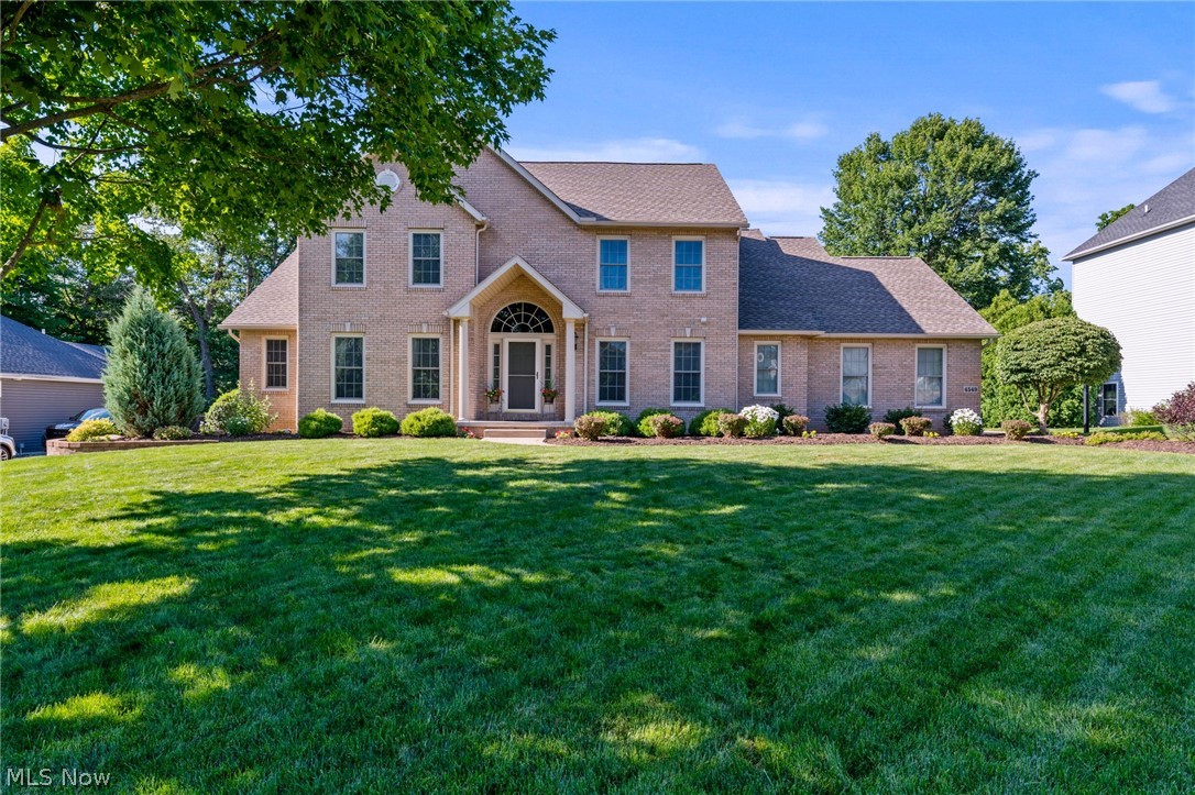 This one won't last! This custom-built brick front home offers over 4,500 square feet of finished living space, a first-floor primary suite, an amazing finished lower level, and a 3-car garage! The current owners have invested in this home for over 20 years, and it shows everywhere you look!

The two-story great room features a gas fireplace along with an open staircase overlooking the living area. Need a first-floor office? You've got it! The large kitchen offers white cabinetry, granite countertops, a center island, and plenty of workspace. The kitchen opens to the spacious dining area with a wall of windows overlooking the backyard. The first-floor primary suite is complete with a beautifully remodeled ensuite bathroom featuring double sinks, a soaking tub, oversized shower, and a huge walk-in closet.

Upstairs you'll find three generously sized bedrooms and a completely remodeled full bathroom completed in 2025. The finished lower level is an entertainer's dream! Whether you're watching the big game or gathering around the custom wet bar, there's room for everyone. There's even another full bathroom downstairs! This space is absolutely wonderful!!

Outside, you'll love the custom Trex deck with pergola and lighting overlooking the beautifully landscaped half-acre lot. The backyard also features a fire pit area, retaining wall, and plenty of room to spread out.  The home is located towards the end of the road, so traffic is minimized. 
The list of updates is impressive! Kitchen remodeled in 2009. Primary bathroom remodeled in 2014. Second-floor bathroom completely remodeled in 2025. Roof replaced in 2020. Furnace 2017. Water heater 2014. Pella windows added in 2011 and 2017. Custom finished basement completed in 2007. Trex deck with pergola and lighting added in 2019. New insulated garage doors in 2014. Refrigerator new in 2026. Microwave and dishwasher new in 2024. EV charger installed in 2026. Home warranty included for added peace of mind!