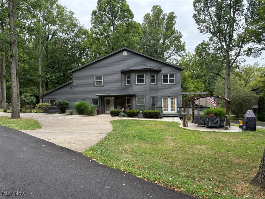 Fantastic lake home, perfect for year round living or your weekend retreat.  Beautiful setting, just a stones throw from the water.  Spacious vinyl sided home with 4 bedrooms and 3 full baths.  Natural sunlight fills the great room with abundant windows and French doors to the wrap around deck. Updated white kitchen features a pot filler and island breakfast bar.  The kitchen opens to the dining room with hardwood floors and electric fireplace that has access to the 24 X 11 screened porch boasting tongue and groove cathedral ceilings.  .  Sliding French doors lead to the main floor office which could serve as a bedroom.  The second floor master suite features pocket doors to the full bath with ceramic tile shower.  Three additional spacious bedrooms and full bath are located on the second floor.  Oversized 2 car attached garage.  2 gas furnaces and 2 central air units.  Corner lot includes gazebo with concrete patio.  Includes a private dock on the water.  Seller is offering an allowance for living room carpet.  MWCD lease fee of $2,343 for 2025.  MWCD lot A9.  Current owner's utilities average $50 for gas, $250 for electric & $52 for sewer monthly (based on full time living).  Room sizes are estimates.