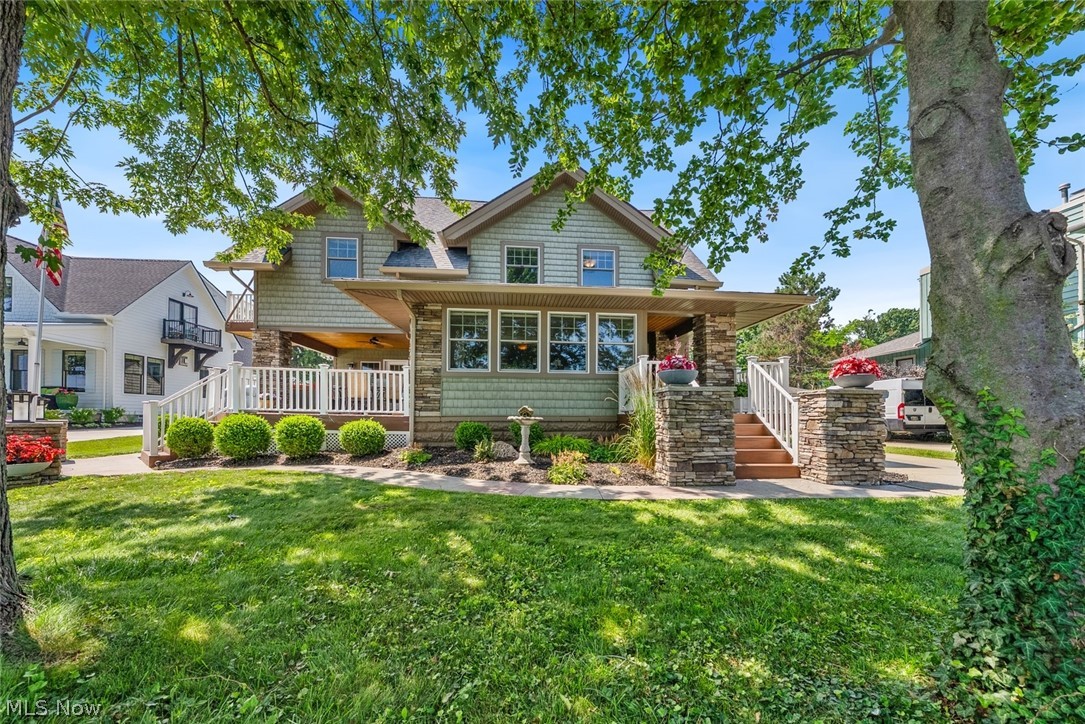 Welcome to 25021 Lakeview Drive, where the address truly speaks for itself. Perfectly positioned across from Lake Erie, this exceptional home offers breathtaking lake views and inviting outdoor spaces designed to enjoy them. A welcoming front porch leads to the entry, while a separate partially covered porch creates the perfect place to relax, entertain, and soak in the ever changing beauty of the lake.  Inside, the living room is anchored by a striking stone fireplace, and the front sitting room frames picturesque views of Lake Erie, creating the perfect place to enjoy your morning coffee or unwind at the end of the day. The stunning kitchen is the heart of the home, featuring stainless steel appliances, beautiful cabinetry, a marble center island with seating, and an adjoining dining area designed for both everyday living and effortless entertaining. A convenient half bath completes the main level.  Upstairs, you'll find four spacious bedrooms, including a serene primary suite with a private balcony overlooking the lake. The spa-inspired en suite bath features dual granite vanities, a soaking tub, and ample closet space. Three additional bedrooms, a full bath, and a conveniently located laundry room complete the second floor.  The unfinished basement along with the oversized garage provides abundant storage. With panoramic Lake Erie views, thoughtfully designed interiors, and an exceptional Bay Village location, this home offers a lifestyle that is remarkable.