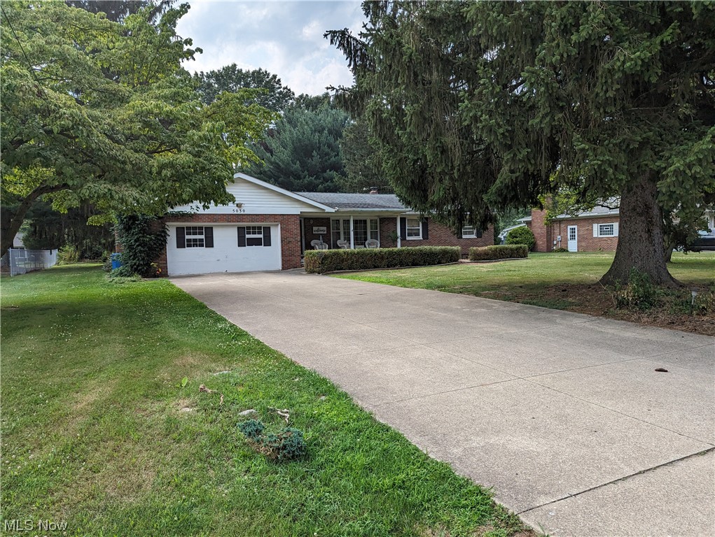 What an incredible opportunity to make this 4+ garage quality brick ranch house on a .46-acre lot in a relaxing neighborhood your new place to call home! Indulge in the nice location and convenience of being within miles of Portage Lakes State Park.

Step out onto the exceptionally inviting covered front porch to unwind with a good book or enjoy a morning cup of coffee. Upon entering this home is the primary living room with hardwood flooring and a sizable picture window. Enter the dining area as a fabulous focal point of the home with a delightful garden window. The oak-finished kitchen has abundant cupboard space and a range of utilities, including a refrigerator, microwave, dishwasher, and garbage disposal. Two bathrooms, each located conveniently on each side of the house. Three bedrooms are located on the right side of the home, while an additional cozy living area makes up the left side of the home with brick walls, a gas log fireplace, and access to a deck. The deck has a buil