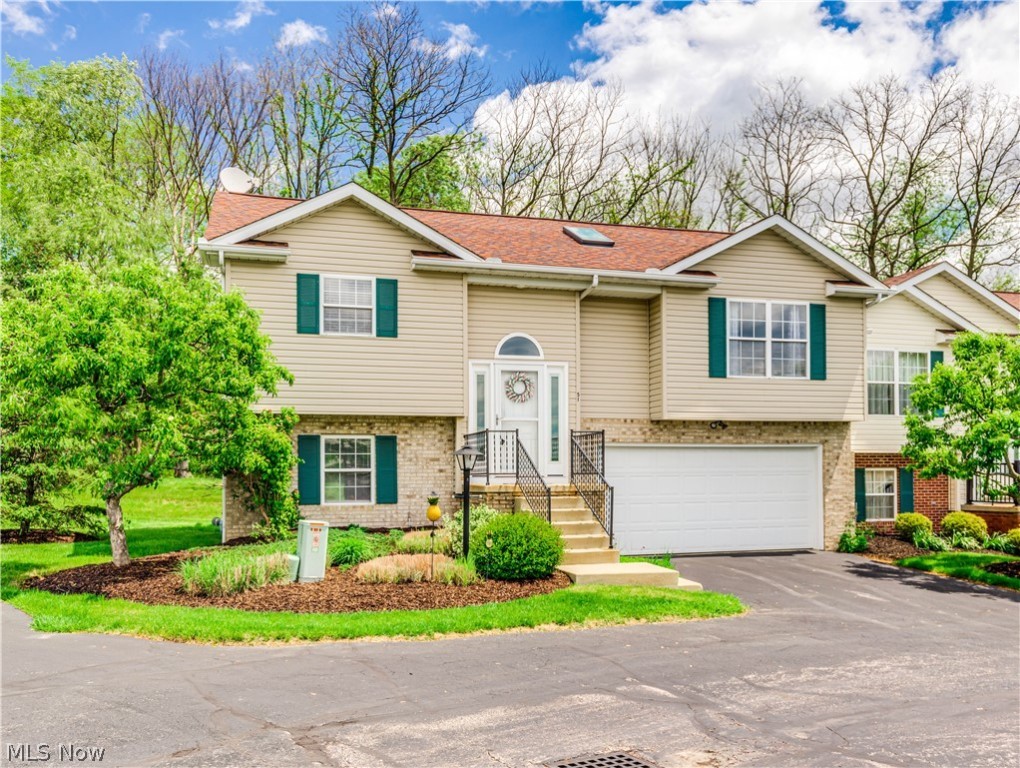 Impressive 2 or 3 bedroom condo with 2.5 bathrooms and a two car attached garage .  This  end unit has great curb appeal and a semi private backyard overlooking a wooded park like area from the large deck porch or from the lower level walk out patio. Step through the foyer entrance into the open and spacious Vaulted Great Room and Dining Area filled with natural light . Extensive updates throughout includes luxury vinyl floors, carpet, neutral paint and trim, light fixtures, fans, water heater,garage door and opener, appliances  and more. Beautifully redone kitchen and bathrooms with quality materials and finishes throughout.  The lower level is a spacious and bright family room with sliders to the patio. It has an area for a closet and could easily be converted to a third bedroom if needed. The condo sits up  high enough to see beautiful sunsets and catch the fireworks on the 4th! Close to the River and hike and bike trail.