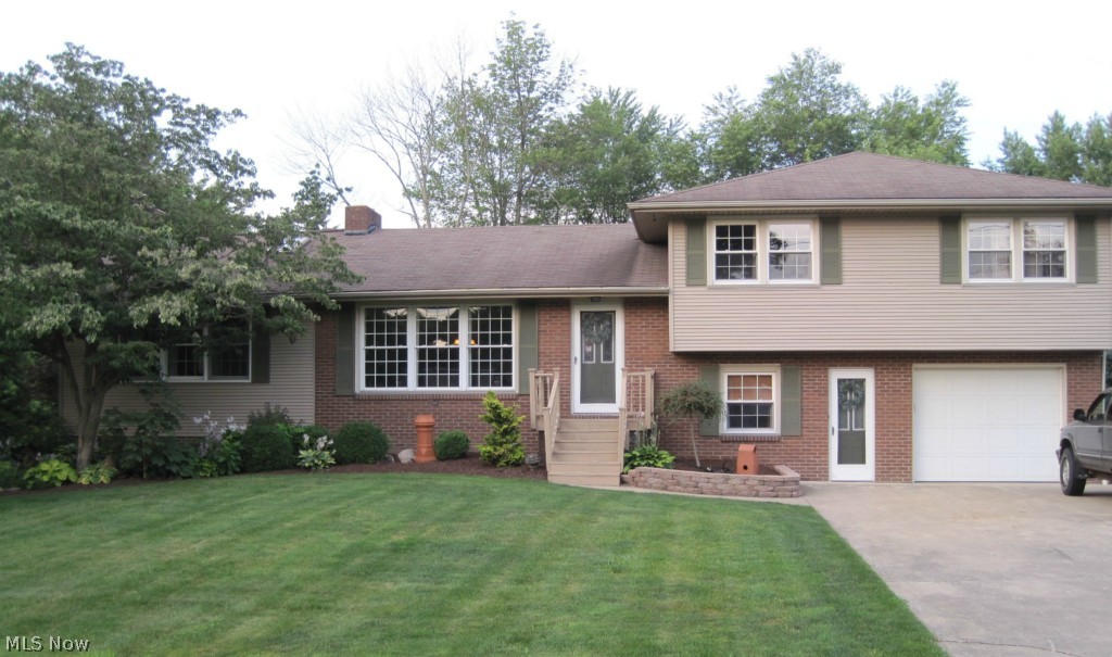 Spacious 4 bedroom, 2 bath split level situated on a large corner lot which has been beautifully landscaped.  Enjoy the updated kitchen and  amazing great room complete with wood burner insert. Media room on lower level to spend quality time with family.  Plenty of garage space to satisfy the car buff...1 car garage is attached/heated and the other, 2 car garage is detached. This home has been loved and well maintained. Tuslaw Schools.   Additional parcel #7202192 (60X175), taxes $127.60(which is included in the taxes listed above).  #7202191 (60X175) $12.00 Muskingum Water Shed assesment paid annually.