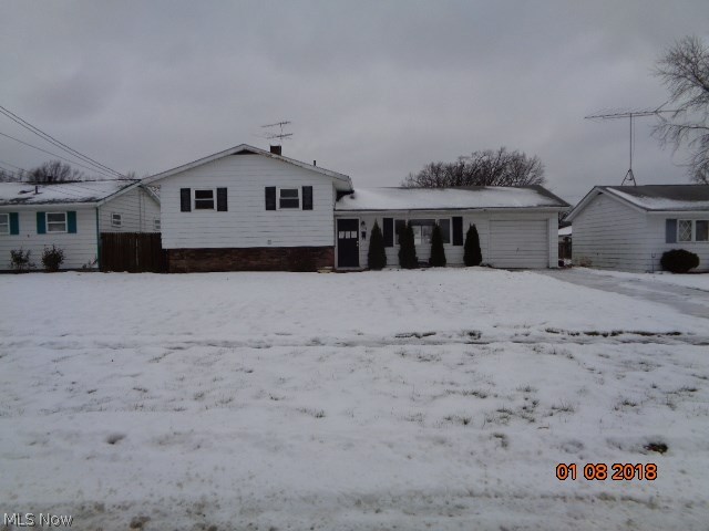 Thee bedroom Split level with open kitchen dining area with sliding doors out to large backyard partially fenced! Three bedrooms up with a full bath. Lower level has a possible fourth bedroom or family room.  Separate utility area and a full bath.