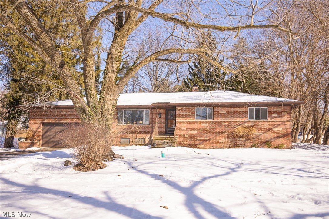 This All Brick Ranch is Nestled on a Rare 1.13 Acre Lot. You Can Enjoy Top Rated North Royalton Schools in a Country Setting. The Dimensional Shingle Roof is 4 Years Young! New Furnace and Central Air Ensures Year Round Comfort. L-Shaped Living Room and Dining Room Features Vaulted Ceilings for a Large, Open Feel. Hardwood Floors and Quality Wood Paneling Give a Warm Rustic Feel to the Living Spaces. The Kitchen is Highlighted with Quality Wood Cabinetry, Quartz Counter Tops, Ceramic Tile Backsplash and Ceramic tile Floors. The Spacious Master Bedroom is Serviced by a Half Bath. In Addition, the Main Floor Provides 2 More Nice Size Bedrooms as Well as a Full Bathroom with Step-In Shower! The Basement Rec Room is HUGE and Provides 672 Additional Square Feet of Living Space. The Attached 2 Car Garage is Accessed Through the Basement and Provides Attic For Storage. The Beautiful Yard Provides a Treed View. This is the Perfect Place to Call Home!