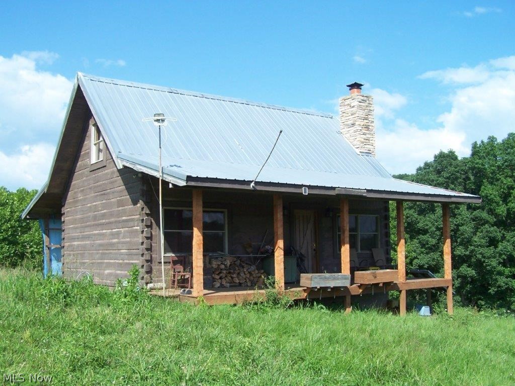 Secluded 65 acres surveyed (easy access) Beautiful Log Cabin. 2 bedrooms, 1 bath, family/media room (or extra bedroom), great-room with fireplace, kitchen, dining room, utility room, covered front & back porches. View countryside  and abundant deer, turkey, wildlife! Small creek, timber, meadows. Drilled well & septic. Solar power electric & generator. Be self sustaining! Garden area. Wonderful location. Cabin is in center of property- as private as you can get! Storage building & chicken house. Locked gate & security system.