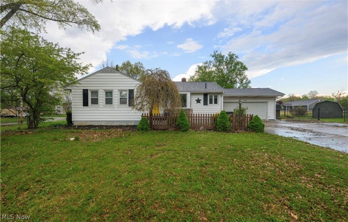 Nestled on a nearly half-acre corner lot in a peaceful, quiet neighborhood, this charming ranch offers the perfect blend of modern updates and comfortable living. Attractive curb appeal welcomes you home, highlighted by a new roof and gutter guards installed in 2023 for added peace of mind. Inside, you'll find a fresh and inviting atmosphere with updated neutral paint throughout the main living areas and two comfortable bedrooms. The thoughtfully designed layout provides a functional flow, with the full bathroom conveniently tucked away from the main entertainment spaces. The kitchen serves as the heart of the home, offering ample cabinet space, an open-concept feel, and all appliances included, making your move-in process seamless. Just off the main level, the partially finished basement provides valuable additional living space ideal for a home office, gym, recreation room, or hobby area. A shower and sink are already in place, offering the potential for an additional full bathroom with the installation of a toilet. Step outside to enjoy the fully fenced backyard, perfect for pets, play, or entertaining. The spacious deck creates an ideal setting for summer gatherings and weekend cookouts. Storage is plentiful with a two-car garage and two additional storage sheds. Major mechanical updates include a new hot water tank in 2024, central air installed in 2018, and a furnace replaced in 2015. Combining important updates, generous outdoor space, and a desirable location, this well-maintained home is ready for its next owner. Immediate possession available. Schedule your showing today before this opportunity is gone!