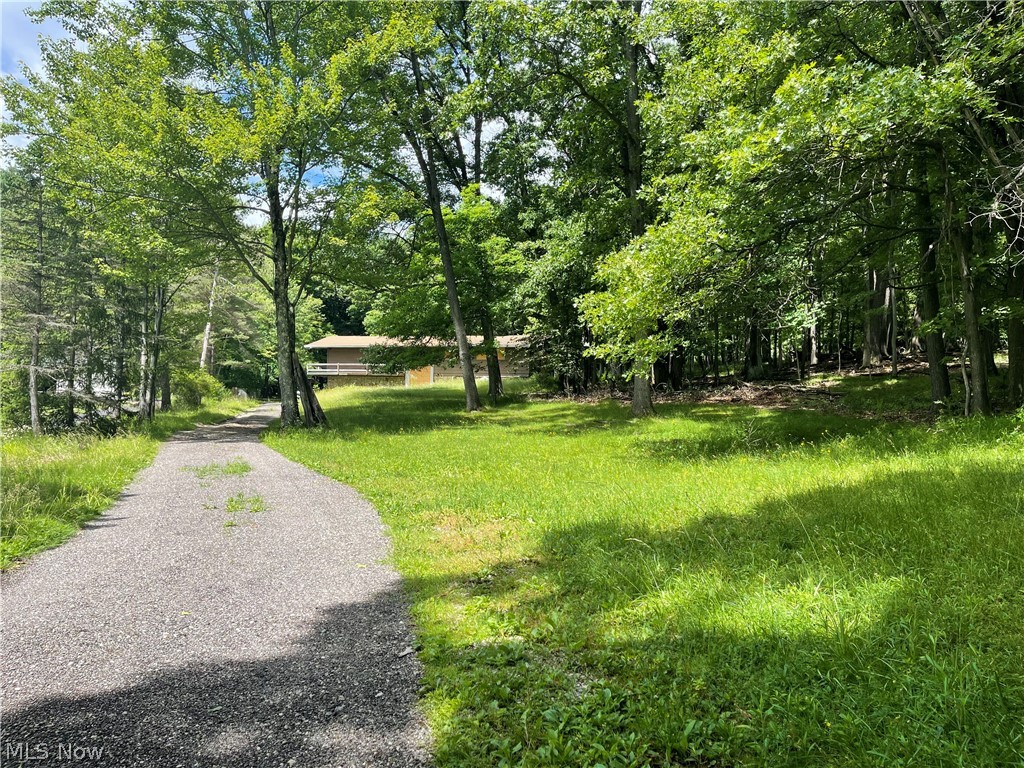 Looking to build your dream home? Welcome to 8456 Whitewood Rd. in beautiful Brecksville! No HOA! Wooded lot with lots of nature to enjoy. Seller agrees to resolve septic issue prior to closing per county and city requirements. Buyer to tie into city sewer after title transfers. Structures are believed to be UNINHABITABLE.  HOUSE IS NOT A "FIXER UPPER". BUYER TO TEAR DOWN HOUSE. This is a unique opportunity. Central location close to shopping, I-77, restaurants, metro parks and all Brecksville has to offer with Brecksville-Broadview Hts. schools - top schools & sports. Buyer agent must accompany buyer onto property.  No entry into structures.