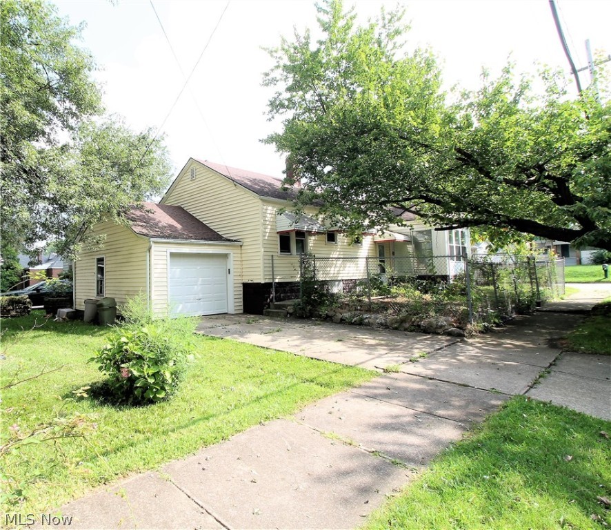 Welcome to this charming updated two bedroom, one full bath spacious ranch home. This fabulous home offers a newer roof, windows and siding. Come on into this freshly painted, new carpet (2021) through out home to the living room which has large windows to let the natural light shine through and is open to the large dining room which has a built in cabinet and leads to the bright kitchen with plenty of cabinets, new vinyl flooring, refrigerator and stove. The full bright bathroom has new vinyl flooring. There are two large bedrooms that have ceilings fans. Lower level offers plenty of space for entertaining, work out area, etc.  You will find an enclosed patio area for you to sit out and enjoy. There is an attached one car garage. Fenced in area. Beautiful backyard to sit out and enjoy or entertain. New Hot water tank. Precious memories begin right here!