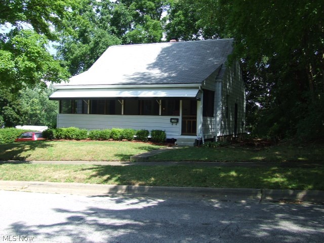 Stop and see this cape cod style home that is much bigger than it appears.  Sitting on a double lot, this home has a nice sized, flat back yard and mature trees.  Inside this immaculate home you will find a neutral living room, kitchen, and extra large first floor family room.  Two bedrooms with original oak hardwood floors and a full bath complete the main living area.  Upstairs is a large dormer style bedroom, big enough to share.  The partially finished walk-out basement has a large finished rec room with built-ins, a laundry room with a bonus shower, and a workshop area with access to the attached one car garage.  Updates include windows and electric in this well maintained home.  Home warranty included.