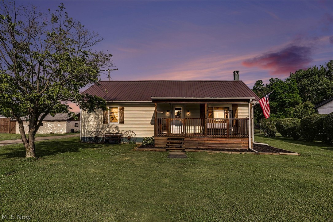Welcome home to this beautifully updated 3-bedroom, 1-bath residence that perfectly blends rustic charm with modern farmhouse. Situated on a desirable corner lot, this unique property features eye-catching interior details including corrugated metal accents, warm wood slat ceilings, and a custom farmhouse-inspired design throughout. The thoughtfully designed bedrooms showcase custom-made barn door style closet doors, adding character and craftsmanship while complementing the home's rustic aesthetic. Step outside and enjoy the spacious covered front porch or entertain guests on the large covered back deck. The raised flower beds offer a perfect space for gardening enthusiasts, while the basement storm shelter provides added peace of mind with convenient access from both inside and outside the home. Car enthusiasts, hobbyists, and those needing extra storage will appreciate the huge heated 4-car tandem garage. The corner lot provides additional outdoor space and curb appeal. This home has been well maintained with numerous recent updates, including plumbing replaced approximately 3 years ago, an updated electrical panel (7 years ago), a new furnace and central air system installed just 2 months ago, a water heater approximately 5 years old, dishwasher replaced 2 years ago, refrigerator replaced 2 months ago, a new sump pump, and a metal roof installed in 2020. Combining thoughtful updates, rustic charm, and exceptional functionality, this move-in-ready property offers comfort, character, and peace of mind for years to come. Professional Photos coming 6/12/26