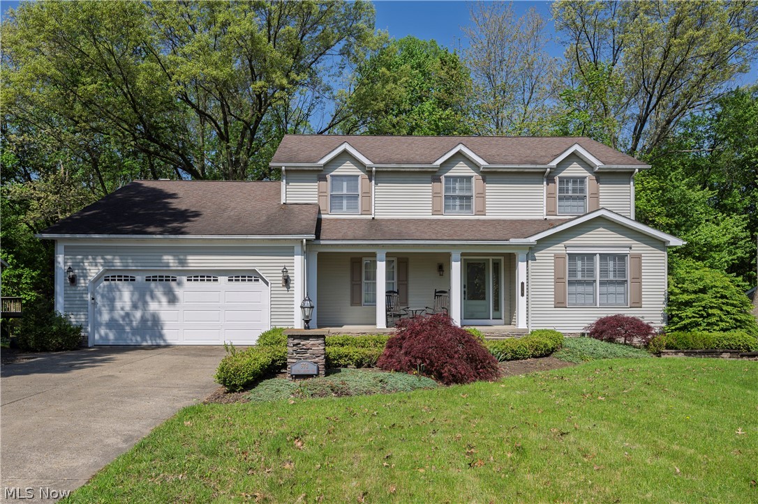Welcome to this beautiful custom colonial home featuring four spacious bedrooms, two and a half baths and stunning hardwood floors throughout. Thoughtfully designed with elegant shaker panel accents, this home offers comfort and character at every turn. Enjoy finished bonus room in the walkout basement, perfect for added living or entertainment space. Cozy up by the wood burning fireplace or take in the peaceful setting from the private wooded lot. Located within the highly sought-after Revere Local School District, this is a home you don't want to miss!!