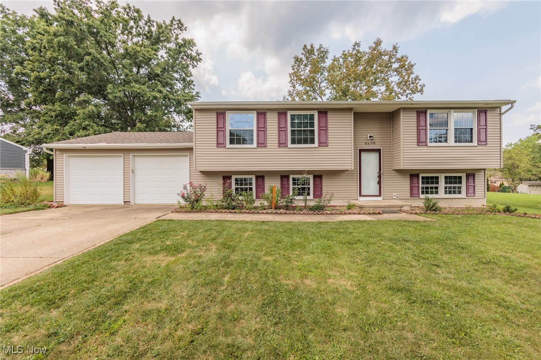 Welcome to this beautifully updated split-level home, featuring 5 generously sized bedrooms and 2 full bathrooms. The home offers a seamless blend of comfort and style with its freshly painted interior and newer flooring throughout. The spacious kitchen is a highlight, boasting updated appliances that cater to both daily living and entertaining. An attached two-car garage provides convenient access, while the sliding doors off the kitchen open to a newly painted deck, perfect for outdoor dining or relaxing. The deck overlooks a large, well-maintained backyard, offering plenty of space for outdoor activities and gardening. This home is designed to provide a modern, comfortable living experience with thoughtful updates and ample space for family and friends.