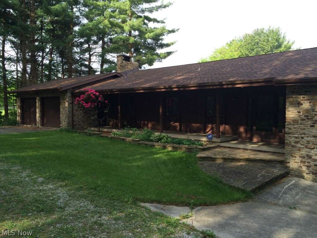 Charming, private lake-front ranch house situated on an idyllic wooded lot with over 8 acres of land!  This house has two full levels of living space, a 4-car garage (each end of the house has a two-car attached garage.  One of the bays in the left-most garage is used up by utility room space), a deck that covers the span of the entire house off the main level, a lovely lake-front concrete patio with diving board.  This property has a greenhouse & a two-stall horse barn well-equipped for the equine enthusiast.  The lot also contains pasture, lawn, and raised-bed garden spaces.  The seller has made some recent updates.  New roof (2013); well (2013); activator for septic (2013); radon mitigation unit installed (2012).  The lower-level of the home is need of some cosmetic renovations following a severe weather event in 2013 that brought lake water into the home.  The damage on that level has been mitigated & it is prepped for renovations.  Oil and gas income. Free gas owned by seller to t