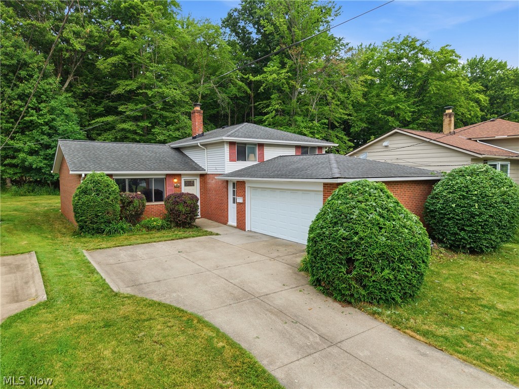 Opportunity awaits this 3 bedroom split-level home offering a functional floor plan, generous living space, and a fantastic location close to schools, parks, shopping, and everyday conveniences. Step inside to the living and dining room, the perfect space for entertaining or relaxing. The kitchen features a newer refrigerator and range, a convenient eating area, and overlooks the spacious lower-level family room. The lower level also includes a half bath along with a combined laundry, mechanical, and storage room, providing plenty of practical space with garage access. Upstairs, you'll find three comfortable bedrooms, including a primary bedroom with double closets for ample storage. Two of the bedrooms feature hardwood floors, and the full hall bath has been updated with a newer walk-in shower. Additional storage is available in the crawl space, a perfect spot for seasonal items and household belongings organized. Outside, enjoy a peaceful, wooded backyard with a patio that offers privacy and a natural setting—ideal for relaxing, gardening, or creating your own outdoor retreat. This home is being sold as is and offers an excellent opportunity for buyers looking to add their own cosmetic updates and personal style. With solid bones, a desirable layout, a private lot, and an outstanding location, this property is full of potential. Whether you're a first-time buyer, an investor, or someone looking to build equity through thoughtful improvements, this is a chance to make a home your own in an established neighborhood with convenient access to schools, parks, restaurants, shopping, and major commuter routes. Bring your ideas and unlock the possibilities!