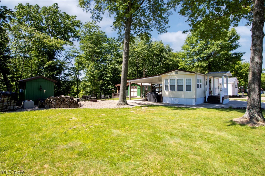 Forget everything you think you know about campground properties - this luxury Ravenwood retreat feels more like a designer cottage getaway than a camper....luxury meets campground living in this stunning 1986 Ravenwood retreat located in the private gated community of October Hill Campground near Mohican. Situated on two lots, this beautifully updated 3-season getaway feels more like a cozy cottage than a camper. From the granite countertops and warm wood ceilings to the spacious screened porch and inviting outdoor entertaining areas, every detail has been thoughtfully upgraded. Enjoy a heat pump with A/C, concrete driveway, outdoor lighting, fire pits, scenic overlook, storage shed, and a separate bunkhouse with window A/C for additional guests. Most furnishings inside and out will remain, making this a true turnkey escape. Extensive improvements throughout create a one-of-a-kind property rarely found in campground living. Bonus second lot provides room to park an additional camper for even more sleeping space. Don't miss this exceptional Mohican-area retreat!