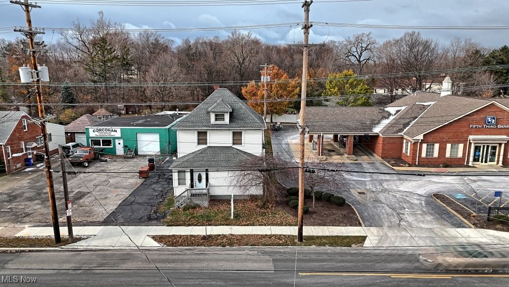 Exceptional commercial value! Meticulously maintained, 3-story office building listed at $139,000 on a heavily traveled Cleveland corridor. Featuring 1,708 SQFT above ground plus an additional 936 SQFT below grade (over 2,600 total usable SQFT), this zoned office property is an investor's dream or perfect for an owner-user looking to stop renting. Currently a long-term, owner-occupied law office. For investors, this property boasts massive cash-flow potential. With 4 separate entrances (front, back, side, and lower level), the building easily subdivides into multi-tenant office suites. Based on area market rents of $14–$18/SQFT, the estimated gross rental potential is $2,500 to $3,200+ per month ($30,000–$38,400+ annually). Factoring in conservative operating expenses, this translates to a projected 14.0% to 17.9% Cap Rate—virtually unheard of in today's market! The interior offers a welcoming lobby, private main-floor office, and full kitchen/cafeteria. The 2nd floor provides 4 private offices and a full bath, while the 3rd level features a private executive suite with tandem access. Hardwood floors are preserved under the carpet. The partially finished lower level adds value with a half bath, mechanicals, additional storage capacity, and a dedicated walk-up exit to the rear lot. Major recent upgrades include a Newer AC (2023), Newer Windows, Roof (2014), and a Newer Concrete Pad. The site also benefits from the City's recent Street Beautification Project with brand-new sidewalks, curbs, and street paving. The exterior features a fully fenced lot with a paved drive and parking for multiple vehicles, backing up to a wooded area. Located next to Fifth Third Bank with immediate access to all major highways. Owner is retiring. Fast occupancy—easy to show!