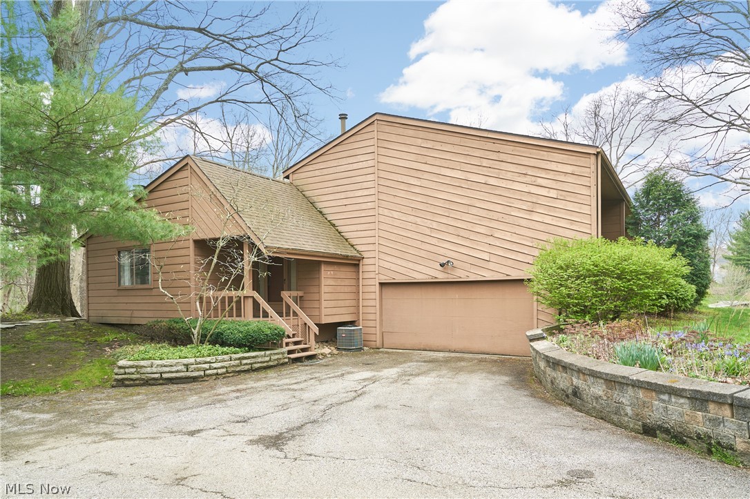 When you buy this townhouse, you buy a lifestyle!  Nestled deep into Granger Lake condos, you are truly surrounded by nature.  This townhouse is multi-level and spacious.  Coming thru the front door, you enter a cozy living room with a big wood burning fireplace.  The adjoining dining room is perfect for entertaining and has a sliding patio door that leads out to a very large deck.  Totally surrounded by trees, you feel like you are in the woods.  The ample kitchen has loads of cabinets and counter top space.  Refrigerator, Stove and dishwasher all stay.  Upstairs is 2 bedrooms, 2 full baths and laundry (washer and dryer stay).  The master suite is good size with a large walk in closet and it's own split bathroom.  Heading downstairs, there is a half bath, mechanicals and a door leading to a 2 car garage.  Further downstairs is a nice size rec room with sliding patio doors that walks out to a patio.  Granger lakes includes lake privileges for fishing, canoeing and paddleboards, a clubhouse, tennis/pickleball courts, and lots room to roam.  Truly a special place to call home.  Highland School District.