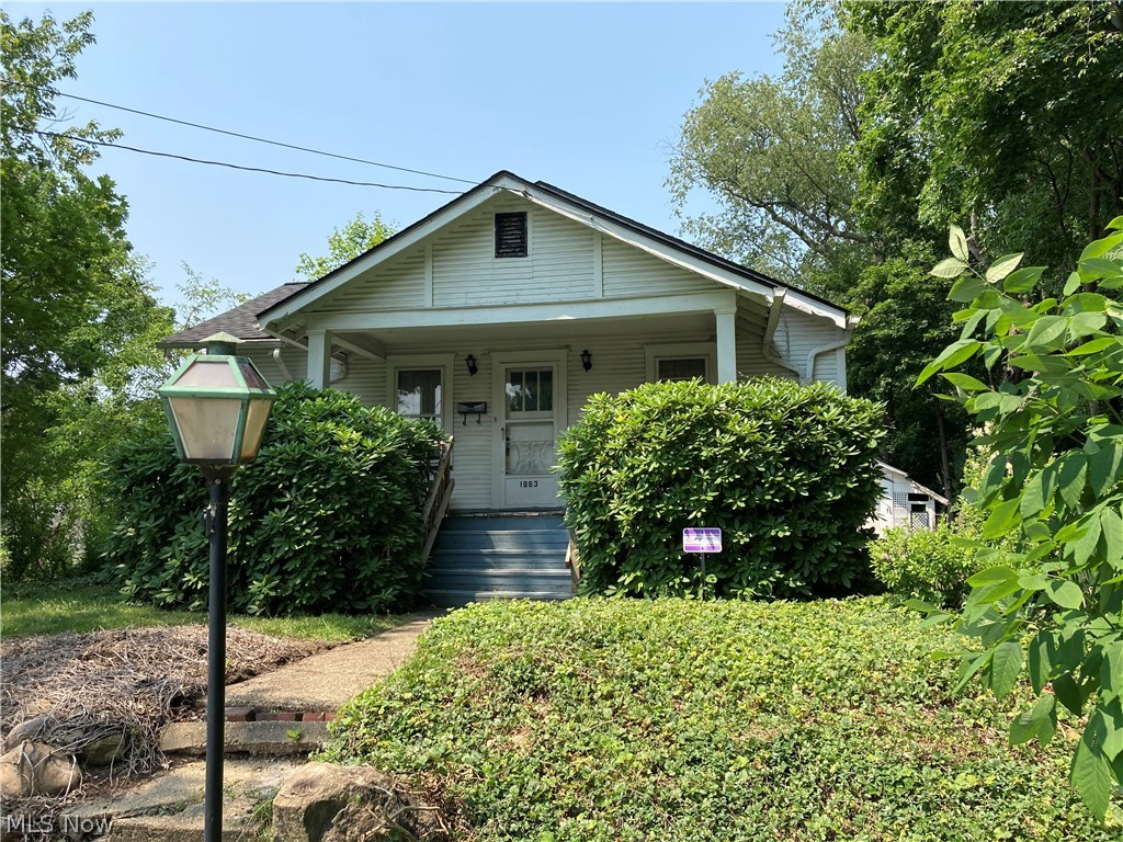 Cute Bungalow on a dead end street with mature trees that sits beside the Goodyear Metropolitan Park.  This home has been in the same family since it was built. The house has 3 bedrooms and 1 1/2 bathrooms with a two car detached garage and an attached carport area where you can lounge on your furniture and enjoy the view and peace on this quiet street.  The roof is only one year old.  Under all of the carpeting is hard wood flooring, which are probably in good shape since the owners did not have any pets.  The wood trim is beautiful as you enter the home into the family room area. The lower level has a fruit cellar and ample storage.  The washer/dryer, stove, and refrigerator (new) are all staying with the purchase of this home.  This home is situated in the Ellet Schools.  The house is sold in AS-IS condition.  Come and view this one of a kind home!