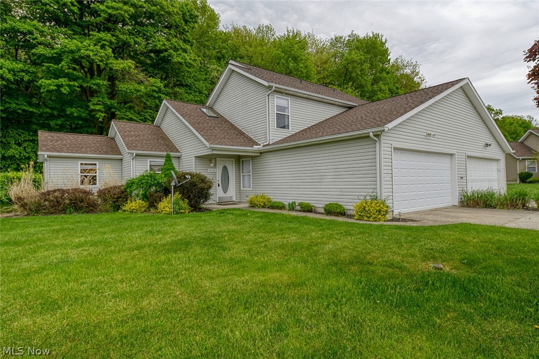 This lovely end-unit condo is conveniently located near I76 and NEOMED, yet feels quite peaceful and serene with the beautiful wooded views behind the property.  The home has all the convenience of condo living yet is very spacious and open, with skylights strategically placed to allow for more sunlight.  The kitchen and baths have been updated with stainless steel appliances and granite countertops.  The extra room off the living room - rare in this neighborhood - provides a quiet place for study, or playroom or gameroom...whatever you need.  The kitchen includes a breakfast bar and ample cabinet space for all your needs and all appliances convey with the unit.  There's a main floor bedroom and bath, and upstairs you will find two more bedrooms with a jack & jill bathroom.  All bedrooms have large closets, so storage is not a problem here.  The 2 car garage has extra space for storage and includes a garage door opener and both electric and cold water.  Access the home directly from th