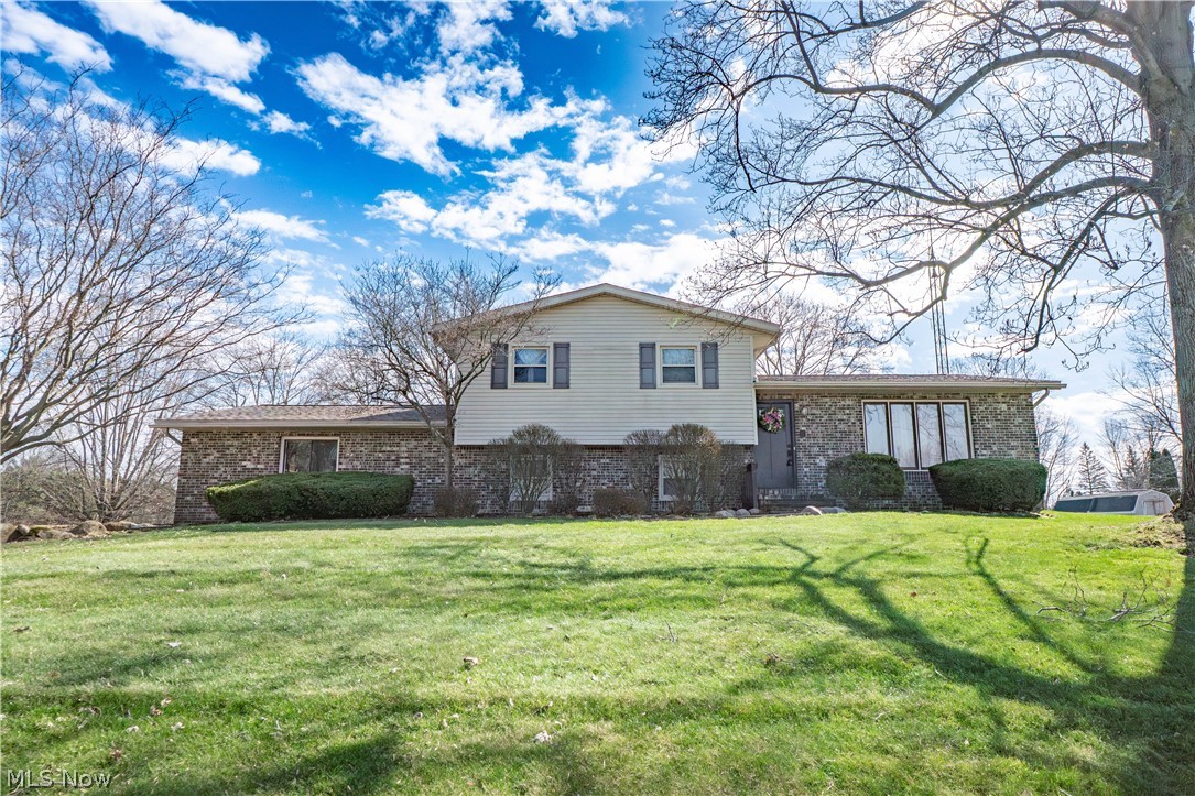 Nestled on a generous .46-acre lot in Uniontown, this well-cared-for split-level home combines space, character, and everyday functionality in a desirable Lake Township setting. Offering 3 bedrooms and 2 full baths, the home welcomes you with a foyer entry, hardwood floors, and a thoughtful layout designed for comfortable living. The main level features a bright living room and an eat-in kitchen with ceramic tile flooring, breakfast bar seating, stainless steel appliances, and sliding doors leading to the covered back patio for easy indoor-outdoor living. The lower-level family room is full of charm with its dramatic stone wall and decorative fireplace, plus an adjoining office/flex space, mudroom, and full bath with shower—ideal for guests, hobbies, or working from home. Upstairs, the primary bedroom includes two closets, with two additional bedrooms and an complete remodeled full bathroom by Hartville Hardware Store featuring a beautifully finished tub/shower surround and sliding glass doors. The unfinished basement adds laundry space and room for storage. Outside, enjoy the wraparound driveway, additional rear parking, covered patio, and expansive backyard. Solid, spacious, and full of potential, this home is ready for its next chapter.