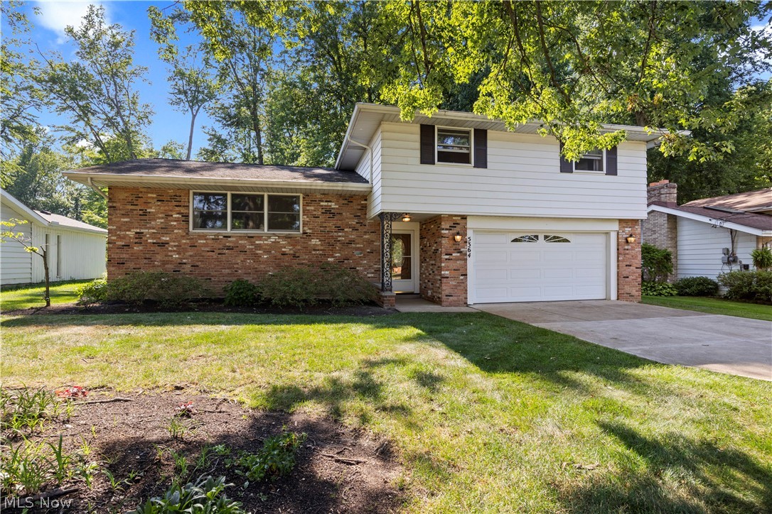 Welcome home to 5364 Hampton Drive in North Olmsted! This beautifully updated 4-bedroom split-level home features an open floor plan that is perfect for day-to-day living and entertaining. From the moment you step through the brand-new front door, you are greeted by a grand foyer that opens into a spacious living room, dining room, and kitchen. The main living areas offer an airy feel, complete with vaulted ceilings. The stunning, updated kitchen is truly the heart of the home, featuring gorgeous, brand new stainless steel appliances and beautiful cabinetry. It flows seamlessly into the living and dining areas, making it ideal for gatherings. Just a few steps down, you will find a bright & comfortable family room with built-in shelves, a fireplace, and direct access to the patio and oversized park like backyard. This level also includes a half bath and a huge pantry/closet as well as garage access. Upstairs, there are four generously sized bedrooms, all freshly painted and updated with new modern ceiling fan lighting. including a spacious primary suite with a full bathroom. An additional full bathroom with a bathtub and both bathrooms recently modernized completing the upper level. The lower level provides a large laundry/utility area with plenty of extra storage space. Recent Additional Updates Include: New electrical work throughout the home & updated panel, New flooring, New light fixtures and ceiling fans, and entire home freshly painted throughout. This home is completely move-in ready with plenty of space both inside and out. Don't miss this exceptional opportunity schedule your private showing today and experience all this special home has to offer!