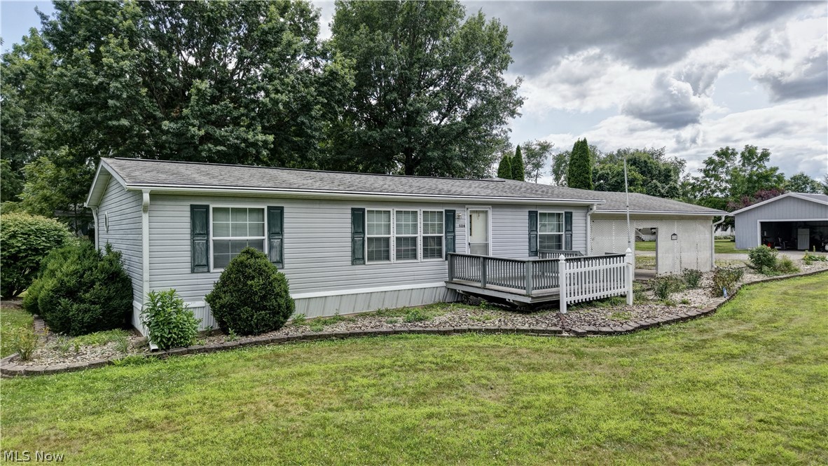 Welcome to 5338 Angela Dr NW in Beach City! This well-maintained manufactured home offers 3 bedrooms and 2 full bathrooms with a comfortable, functional layout. The home features a bright sunroom, providing a great space to relax and enjoy views of the outdoors during the warmer months. Outside, you'll find exceptional parking and storage with an attached 2-car carport, attached 2-car garage, and attached barn, offering plenty of room for vehicles, hobbies, equipment, or a workshop. Situated on a leased lot with monthly lot rent of $450, which includes water, septic, and trash service, helping simplify monthly expenses. Subject to park approval. Don't miss this opportunity to own a home with abundant garage and storage space in Beach City!