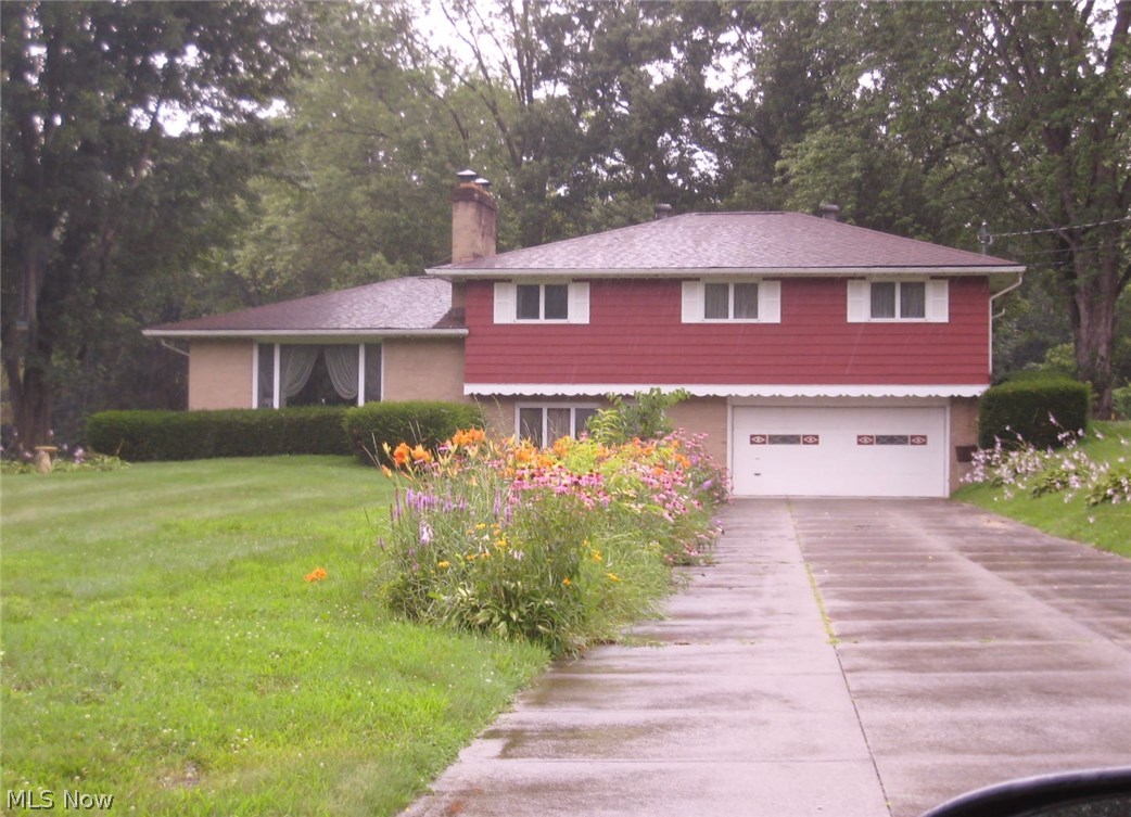 This lovely large 4 level split home sets on a 1.21 acre lot in a lovely, quite neighborhood and backs up to woods.  This pristine home has 4 bedrooms and 2 and a half baths. The large entrance room that could be an office, 1st floor. laundry, and 1/2 bath.  Large master bedroom, walk-in closet, shower, bath and 3 additional bedrooms and full bath.  The home offers hardwood floors in main area living room with fireplace, dining area off kitchen and door to deck and back yard.  Lower level is totally finished with bar and sink, fireplace.  Updates include baths, kitchen, well pump, 2014, roof 5 years.  Septic replaced 8/15.  Home warranty and one car detached garage.
