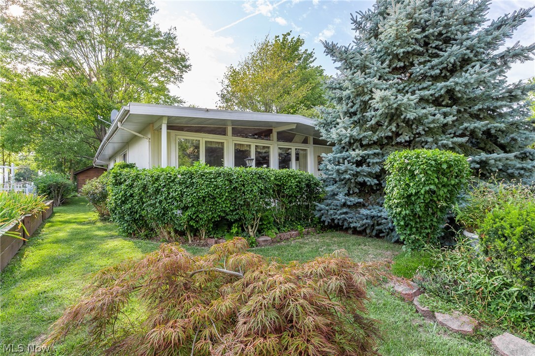 The back-yard includes a 10ft Gazebo with new concrete sidewalks leading to the detached garage and out buildings. Garden shed building sizes 12 x 8 and 10 x 11. Detached garage is 24x24 with 16' wide garage door. The carport is 15x11. 16' Diameter above ground pool located in the back yard. The house sits on a double lot Property is one block deep and goes from Aldrich to Roland Rd. Short distance to like Erie and a nice Brick paver Driveway.