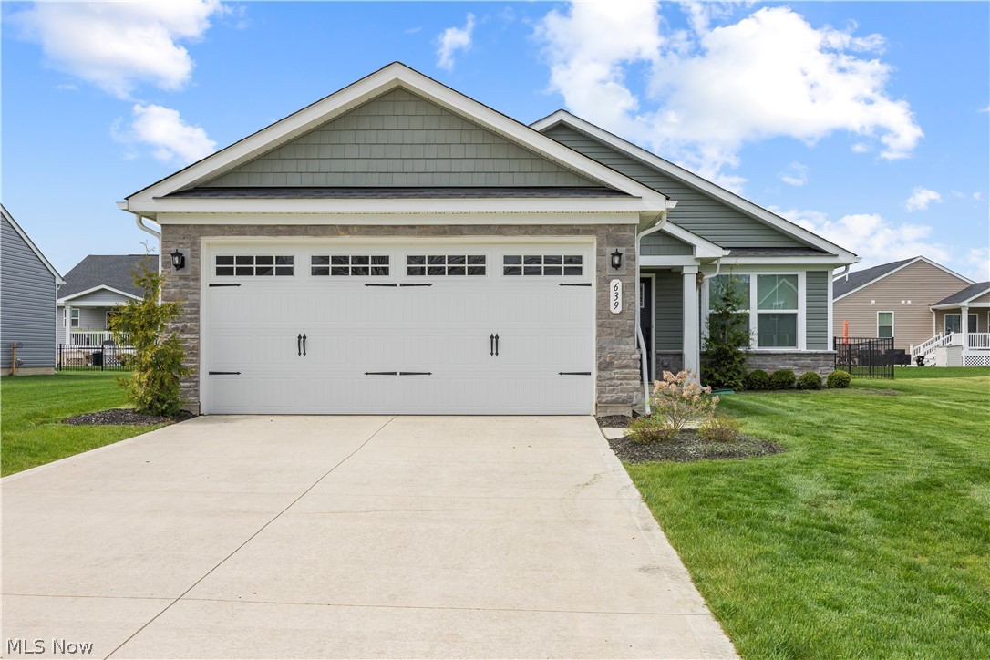 A true gem offering easy, low-maintenance living in the desirable Ridgewater community! With a monthly fee that covers lawn care and snow removal, you can spend more time enjoying your home and less time maintaining it. This beautifully maintained, like-new ranch is perfectly situated on a generously sized homesite, featuring a recently fenced backyard complete with a spacious patio and charming pergola—ideal for relaxing or entertaining. From the moment you arrive, you'll appreciate the curb appeal with its manicured landscaping, stone accents, and welcoming covered front entry. Inside, the home feels bright, airy, and gently lived in. Stylish LVP wood-look flooring flows through the living room and kitchen, creating a modern and cohesive feel. The kitchen is a standout with its crisp white shaker cabinets, quartz counters, center island, and adjoining dining area—perfect for everyday living. The thoughtfully designed layout offers privacy, with bedrooms located on opposite ends of the home. The owner’s suite includes a private full bath with a walk-in shower, while both bathrooms feature attractive tile flooring. A convenient first-floor laundry room and included appliances add to the move-in-ready appeal. Complete with a 2-car attached garage, this home truly is better than building—everything is finished, clean, and ready for you to enjoy from day one!