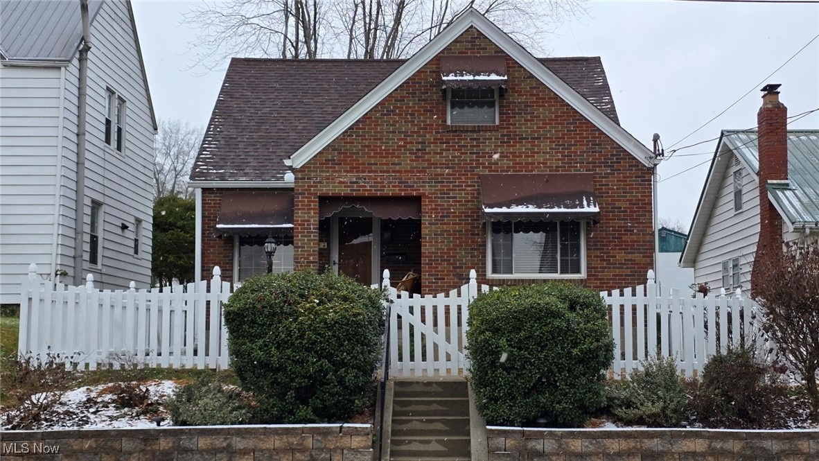 This charming cottage is freshly renovated and move-in ready!  Conveniently located on Broad St, this home is fully clad in brick ensuring low exterior maintenance and plenty of curb appeal.  The wood picket fence is as functional as it is charming- freshly painted and enclosing the front and back yards.  An inviting front porch greets guest from on street parking, and leads into the living room with hardwood floors and a fireplace.  Just to the right, a large eat-in kitchen has been completely updated with new cabinets, countertops, tile backsplash, LVP flooring, and is appointed with a stainless appliance package.  The main level also includes two bedrooms with new carpet, and a full bath- also completely renovated with stylish Kohler fixtures and a tile shower surround.  Upstairs is a third roomy bedroom with a large closet and ample natural light.  A large attic space accessed from this space offers a great storage solution for holiday decor, seasonal clothing, etc.  The basement has a large room that could easily be a fourth bedroom, gym, office or more storage.  There's a large pantry type space near the bottom of the stairs for stocking up on food and cleaning supplies, and the laundry area is roomy and functional, with a convenient utility sink.  A brand new bathroom with walk-in shower has also been added to the basement as well.  Out back, the yard is large enough for kids or pets, and small enough to maintain easily.  A detached garage and carport are accessed from the alley, making for plenty of convenient parking for the owner(s).  With updates such as fresh paint throughout, repainted garage, all new interior and exterior lighting, new landscaping, one year old furnace, and a roof only 2 years old, this home has all the big ticket expenses already covered!  Located near city park, and convenient to shopping and dining.  Schedule a showing to see how this charming cottage could be perfect for you!