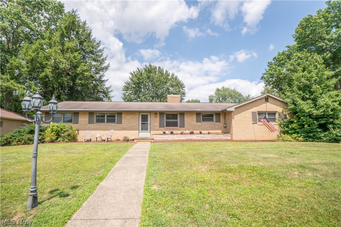 This charming North Canton brick ranch feels like a private oasis while still being close to schools and restaurants, sidewalks, and everyday conveniences. Set on a corner lot, this Weber-built home offers 3 bedrooms, 2.5 baths and a thoughtful layout with no wasted spaces! The foyer welcomes you in with tile flooring, a half wall with storage, coat closet, and new front door. Then flows into the dining room, complete with a built-in hutch that add character and function. Just beyond, the kitchen features newer flooring, wall oven, counter cooktop, pantry, and an easy connection to the cozy living room. The living room is the heart of the home, offering a brick gas fireplace, built-ins, and walkout access to the backyard retreat with a large covered stamped concrete patio, complete with a fan, electric and a side deck for spread out seating area, garden space and fully fenced in yard.
Back inside off the kitchen a hallway leads to the garage, half bath, and a versatile bonus room with a private side entrance and large closet, ideal for an office, hobby room, or guest space. On the other side of the house are three bedrooms with hardwood floors, including a primary bedroom with two closets and another bedroom with a deep closet. The full bath offers newer flooring, an oversized dual-sink vanity, large linen closet, and shower updated in 2019.
The lower level adds even more flexibility with laundry, great storage, three finished bonus rooms, and a full bath with tub/shower combination. With built-ins, hardwood floors, charming details, and peaceful outdoor living, this home offers comfort, character, and a true oasis feel in the heart of North Canton!