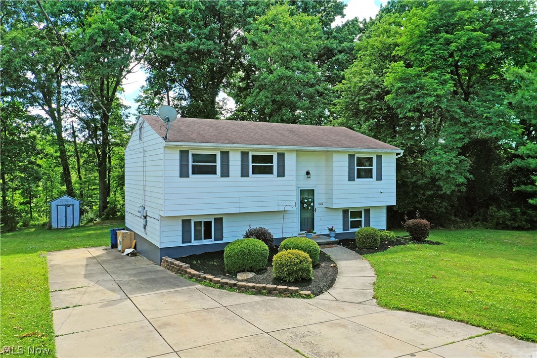Welcome to this well-maintained bi-level home in desirable Weathersfield Township! Offering 3-4 bedrooms and 2 full bathrooms, this home provides flexible living space to fit your needs. The main level features a spacious living room, a bright eat-in kitchen, three generously sized bedrooms, and a large full bathroom.

The lower level offers even more living space with a fourth bedroom and an additional full bathroom, or the room can easily be used as a comfortable family room. You'll also find a versatile bonus room that's perfect for a home office, playroom, hobby room, or extra storage. An expansive laundry room and walk-in closet. 

Freshly painted with new carpeting in bonus room and stairs.

Step outside to enjoy the large rear deck overlooking a private, wooded backyard—an ideal setting for relaxing or entertaining. Additional highlights include a double-wide concrete driveway and a peaceful location with plenty of privacy.

Don't miss the opportunity to make this versatile home your own—schedule your private showing today!