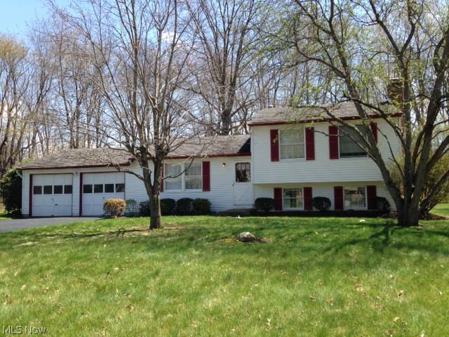 Cozy multi-level 3 bedroom, 2 bath home in a well-established neighborhood~ featuring open kitchen/dining area that overlooks large treed back yard.  Peaceful setting yet conveniently located near schools, shopping, and dining.  Large family room with fireplace on the lower level.  Patio for relaxing and summer grilling.  Attached 2-car garage.  Home Warranty.  Move right in!  Basement water proofed May 2014!
