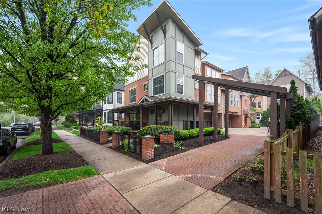 Live on one of Ohio City’s most photographed historic streets!! This standout property is located in a beautiful, walkable, tree-lined setting surrounded by a blend of timeless century homes and thoughtfully designed newer construction. A custom steel handrail gracefully spans from the first floor through the upper levels, guiding you as you move through the home and serving as a defining architectural element that establishes its modern aesthetic from the moment you arrive. This updated 2-bedroom, 2.5-bath townhome offers the perfect balance of character, location, and modern comfort. The main floor centers on a massive great room featuring a contemporary gas fireplace, soaring ceilings, and expansive windows that fill the space with natural light. The fully renovated chef’s kitchen is a standout, complete with quartz countertops, a large island with breakfast bar seating for four, high-quality soft-close cabinetry, double wall ovens, and abundant storage. Adjacent to the kitchen is a spacious dining area that comfortably seats six. Just off the kitchen and dining area, a full wraparound butler’s pantry serves as an extended entertaining space, featuring a wet bar and wine fridge ideal for hosting larger gatherings, serving, or expanding your prep and presentation area with ease. Flexible living spaces include dual owner’s suites and two loft areas, one of which could be easily converted into a third bedroom. Additional highlights include multiple outdoor areas, including a wraparound front porch, a private composite deck, and a fenced yard with a patio and dog run. Recent updates include major kitchen and flooring improvements, A/C, water heater, porch railing, deck privacy wall, and newer front windows. Just 1.5 miles from downtown Cleveland, with walkable moments from all that Ohio City and Hingetown have to offer.