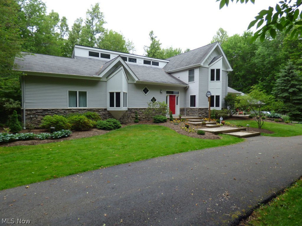This agent owned,  Chagrin Valley beauty with views, is architect designed & gorgeous! The 3.86 acre wooded lot in Derbyshire Estates offers great privacy. Impressive 2 story foyer showcases the clerestory and catwalk. Sunken 26 x 19 Great room has a stone, full wall, gas fireplace with blower. French doors to 3 season screen porch & sound system that remains! Large dining room with French doors to deck also has a full wall china closet & hidden, walk-in closet. Huge kitchen has generous cabinets, double ovens, gas cook top. 4 bedrooms. Large first floor owner's suite with a huge glamour bath & 11 x 12 walk-in closet/dressing room. Refreshed Master Bath has heated towel rack , double sinks/blue pearl granite top and, Jacuzzi tub. True home office w/full walls of custom wood built-ins, & desk area. Spectacular Man-cave/teen hangout in 800 sq ft rec room, full bath, built-in desks/homework station, kitchenette & Murphy bed! Large storage area in basement with stairs to heated garage. Lau