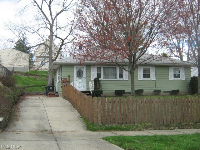 Why rent? Priced below appraised value and much less than rent! Step-saving ranch with beautiful new living room, dining room and hallway carpet (hardwood underneath).  New tub surround and freshly painted bathroom.  Handsome wooden kitchen cabinetry.  Attractive knotty pine paneled rec room with bar (bar stools included).  Ready to move right into! Easy access to I-76 - I-77, close to downtown.