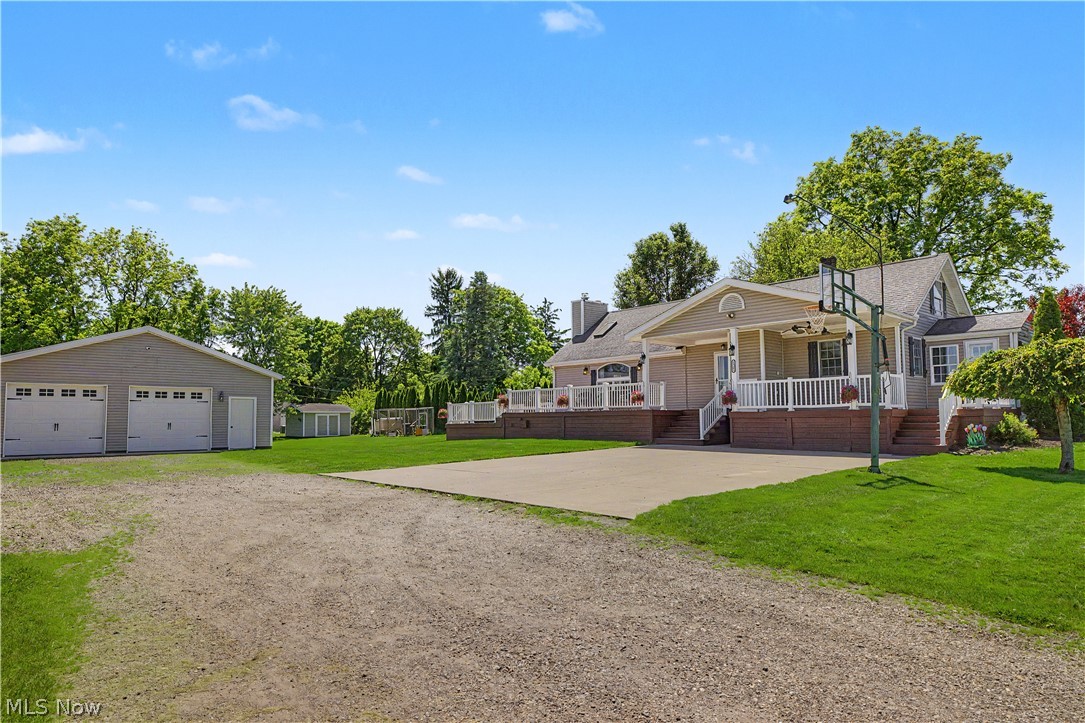 Enjoy the perfect blend of indoor comfort and outdoor living in this spacious 5-bedroom home on 1.04 acres, less than a mile from Tuslaw schools!

The heart of the home features a stunning living room with a cathedral ceiling, skylights, and a cozy wood burning stove. Also enjoy the beautiful kitchen with stainless appliances and an abundance of counter space, the bonus flex room filled with natural light ideal for remote work, a dedicated laundry room complete with built-in storage and a utility sink, and a finished basement. With 5 bedrooms and 2.5 bathrooms, there’s plenty of room for flexible living arrangements.

Outside, entertain on multiple decks spanning over 1100 square feet, relax under the pergola, and take advantage of the massive 40-foot garage that provides room for vehicles, equipment, or projects. Find an additional single car garage, and both a traditional shed and dedicated wood shed. Situated just outside Massillon city limits in Tuscarawas Township, this property benefits from having no city taxes and no zoning restrictions.