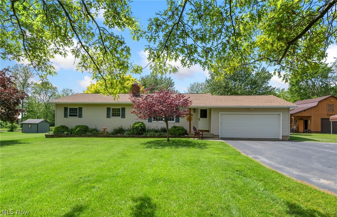 One of a kind, well-maintained ranch located on over 2.19 acres with picturesque beautiful pond and wooded views that offer peace and privacy. This one-floor living home features 3 spacious bedrooms and 1 full bath. The open-concept living area boasts natural light along with the well-appointed kitchen with all appliances, ample counter space and storage, and a separate dining area with access to the covered deck. There is also a versatile outbuilding, which has a working space and a loft on the second level that offers endless possibilities for hobbies, storage or a 3rd car detached garage. The backyard also features a covered deck where you'll find a sense of calm with the views it offers. Included is the stove and washer/dryer. There have been many updates done throughout the years including, roof and gutters (2021), septic cleaned (2024), Anderson windows installed, new blinds (2023), addition added to barn, carport (2020), kitchen remodel, bathroom updates which include new shower, faucets, toilet, and floor (2022), and much more. A full list will be provided upon request. Conveniently located near I-71, I-76, the newly combined Cloverleaf Middle & High schools, the Lodi town center, Outlet Mall, and quick access to Medina, Akron, and Wooster. This home is a must see and a rare find. Schedule your private tour today!