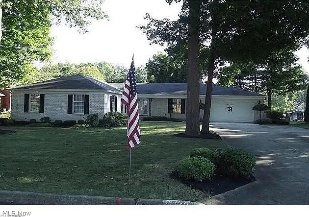 Charming well maintained, beautifully landscaped 3-bedrom, 3-bath executive ranch in Alliance, OH.  Home boasts one floor living, a spacious layout with a welcoming living area and cozy fireplace.  Oversized dining room or additional living area. The kitchen has ample cabinet space and a breakfast nook.  Laundry is also conveniently located on the first floor.  Master bedroom has ensuite and walk-in closet.  Home has a full basement (1925 sq ft) with unique walkout convenient for handyman access to lower-level living and the workshop area. Finished carpeted rec room with wet bar. Additional finished room, bathroom and separate shower.  Overlooking spacious fenced in backyard is a large 3-season room great for entertaining.
Two-car attached garage.  A must see!