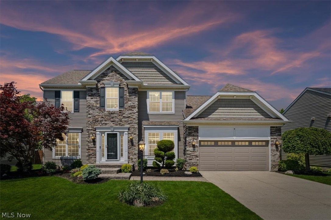 THREE FULL FLOORS OF LIVING. The finished basement is built for entertaining and everyday comfort alike, with a guest suite and adjoining full bath—ideal for overnight visitors or multigenerational living. The expansive rec area centers on a second fireplace and a wet bar with mini fridge, made for game days and movie nights, while a dedicated 14'×15' workout/hobby room—complete with full-length mirrors, TVs, and real gym flooring—leaves no excuse to skip leg day.

Originally the community's model home, this residence makes an impression from the moment you step into the two-story foyer: rich crown molding, detailed woodwork, and gleaming hardwoods carry through the den, dining room, kitchen, sunroom, and second-floor hall. At the front, a versatile den with pocket glass doors pairs beautifully with an elegant dining room dressed in a tray ceiling, crown molding, chair rail, and wainscoting. Toward the rear, the great room welcomes you with a warm gas fireplace framed by gorgeous millwork, flowing seamlessly into a custom kitchen with granite countertops, tile backsplash, center island, pantry, and stainless steel appliances—everything today's cook could want. It opens to a vaulted morning/sun room overlooking the tranquil backyard.

Step outside to an entertainer's oasis: a paver patio, pergola, and storage shed framed by an open farmer's field create a quiet, inviting space for gatherings, grilling, and relaxing. Back inside, a convenient half bath and a customized first-floor laundry room complete the main level.

Upstairs await three spacious bedrooms and two full baths. The luxurious owner's suite is a true retreat—a vaulted ceiling, crown molding, walk-in closet, and spa-like bath with a dual vanity, tile shower, and soaking tub.
*This home also comes with an existing Choice Home Warranty good until 4/16/2027, for peace of mind. Top to bottom, this one-of-a-kind home has all the bells and whistles, and a custom feel you simply won't find anywhere else.