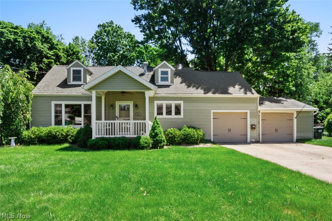 Welcome to 243 9th St NE in Barberton, where thoughtful updates, flexible living space, and a nearly half-acre fenced lot come together in a move-in-ready Cape Cod. Offering 1,960 total finished square feet, this home features two bedrooms and a full bath on the main level, allowing for convenient everyday living, while the spacious third bedroom upstairs includes knotty pine walls, extensive built-in storage, and a private half bath full of character. The remodeled kitchen serves as the heart of the home with granite countertops, a farmhouse sink, dark wood cabinetry, subway tile backsplash, custom range hood, center island with bar seating, and included stainless steel appliances. Arched doorways and original architectural details add charm throughout. The finished basement expands the home's functionality with a dedicated office, emergency egress window, half bath, laundry area with an additional shower, and abundant storage space. Outside, enjoy a covered front porch with swing, a large concrete patio shaded by mature trees, a firepit area, storage shed with electric, and a spacious fenced backyard with room to relax, entertain, or garden. The attached two-car garage offers interior access, automatic openers, and a 220-amp circuit with EV charger. Additional features include gas forced-air heating, central air conditioning, public water and sewer, and a location convenient to local amenities, parks, and commuter routes. Schedule your private showing and discover everything this well-maintained and updated Barberton home has to offer.