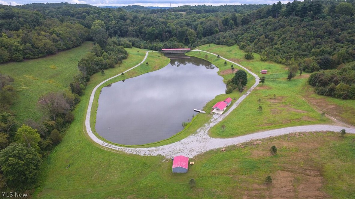 24 acres of paradise with approximate 4 acres lake. Mineral Rights transfer. Situated in Tuscarawas County and includes a 4-5 acre stocked lake, pavilion, picturesque 8x150 covered bridge, 20x20 storage shed, dock, multiple building sites, 8x12 building with an exterior shower, and a gravel drive that wraps around the lake. All buildings have electricity powered by a generator. Pure spring water and convenient location to highways. This property is approved for 3 home/cabin sites. Plan your showing today and explore all the endless possibilities.
